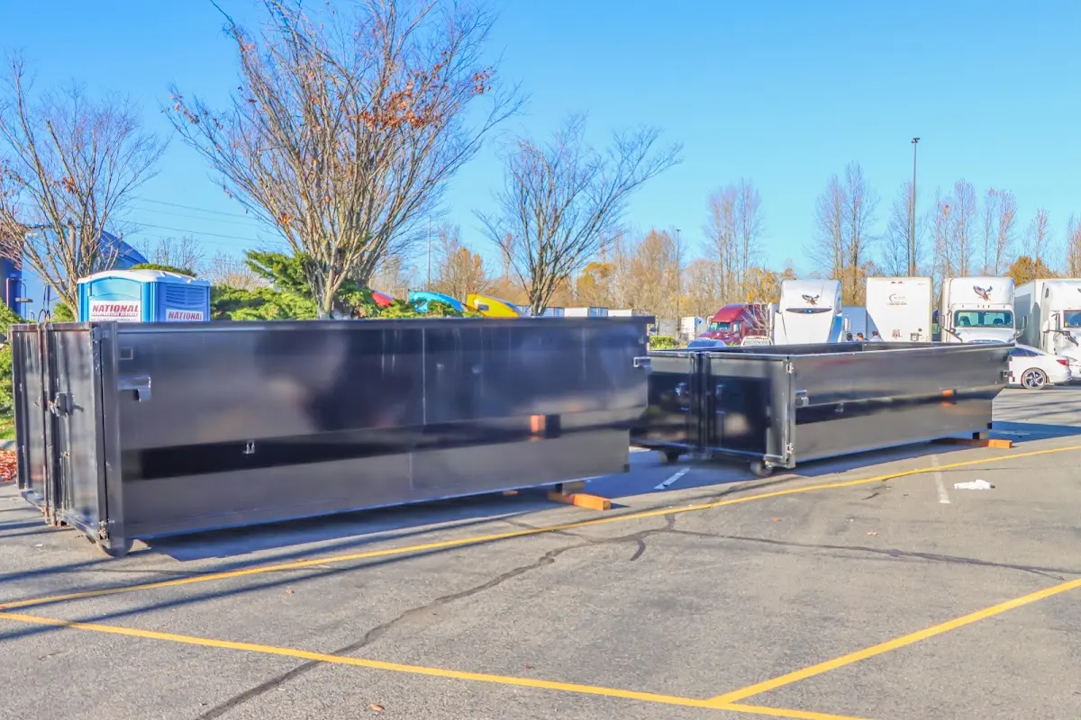 Professional dumpster rental service with roll-off container on residential driveway in Lake Elsinore